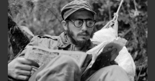 Cuban guerrilla leader Fidel Castro does some reading while at a rebel base in Cuba’s Sierra Maestra mountains in 1957.