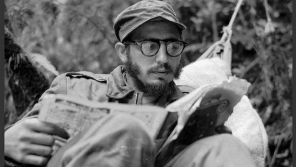 Cuban guerrilla leader Fidel Castro does some reading while at a rebel base in Cuba’s Sierra Maestra mountains in 1957.