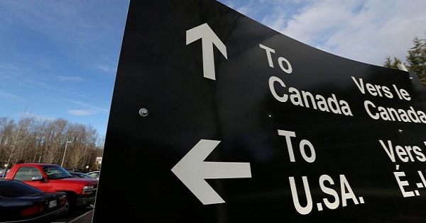 A sign giving directions is seen in the parking lot of the United States-Canada border in Surrey, British Columbia, Canada, Feb. 16, 2017.