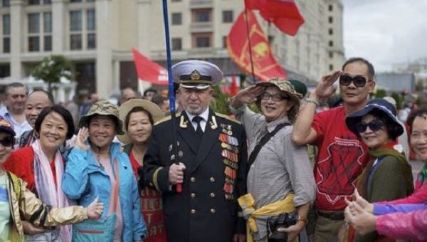 Chinese tourists posing with a former Soviet navy officer in Moscow on Sept. 2, the 71st anniversary of the victory over Japan in World War II.