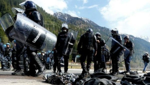 Italian riot police wait for demonstrators during a protest against a plan to restrict access through the Brenner Pass between Italy and Austria, in Brenner .