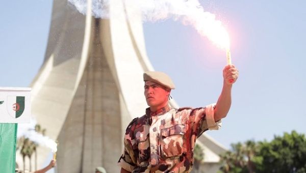 An Algerian parachutist holds a torch during a demonstration to mark Algeria's Independence Day in Algiers July 5, 2017.