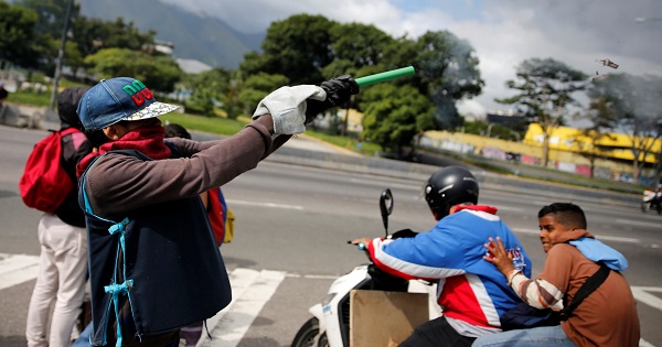 A demonstrator fires a homemade explosive during a protest against the Venezuelan government in Caracas.