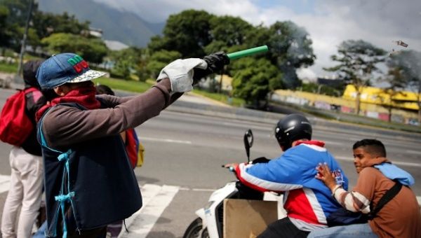 A demonstrator fires a homemade explosive during a protest against the Venezuelan government in Caracas.