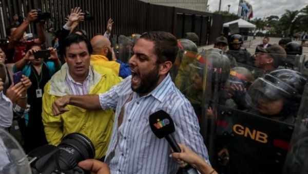 Opposition leader Juan Requesen protesting in front of Venezuela's Supreme Court.