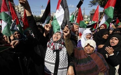 Palestinian women attend a rally calling for an end to Palestinian divisions to mark International Women's Day, in Gaza City, Gaza, March 8, 2011.  