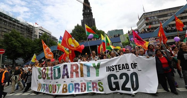People hold flags and banners during demonstrations at the G20 summit in Hamburg, Germany, July 8, 2017.