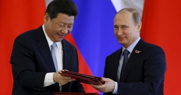Russian President Vladimir Putin (R) and China’s President Xi Jinping.