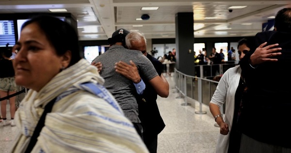 International passengers embrace family members as they arrive at Washington Dulles International Airport in Dulles, Virginia, U.S., on June 29, 2017.