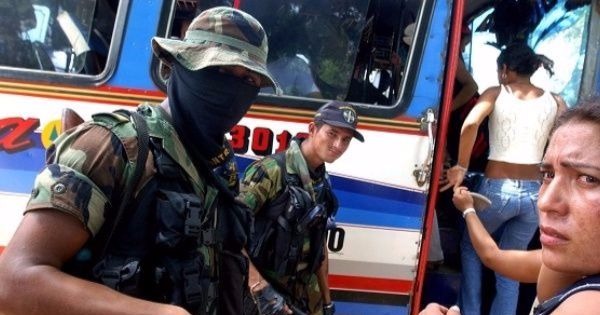 Members of the right-wing paramilitary group the United Self-Defense Forces of Colombia inspect a bus.