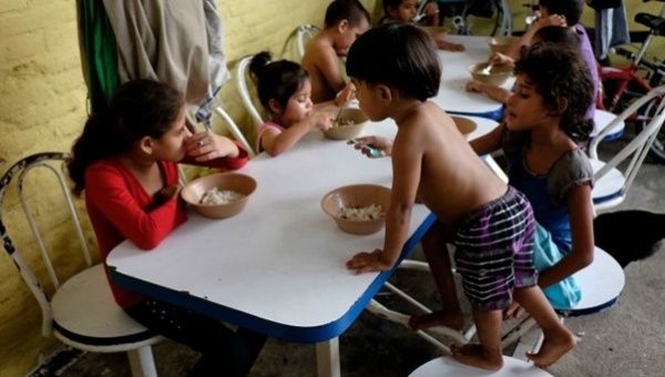 Children from Honduras, traveling with relatives to the U.S., have their meals at the Todo por ellos (All for them) immigrant shelter in Tapachula, Mexico. 