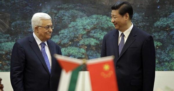 China's President Xi Jinping (L) greets Palestinian counterpart Mahmoud Abbas in Beijing. (FILE)