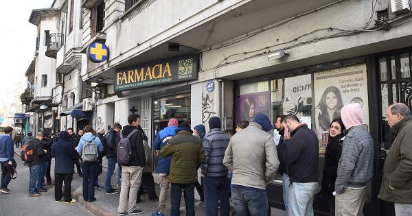 People line up in the early morning in Montevideo to buy marijuana.