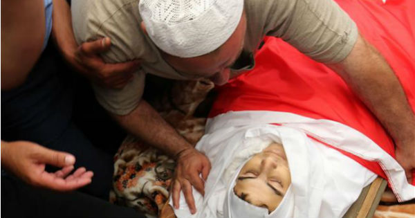 The father of 16-year-old Mohammed Jawawdah mourns over his son's body. Jawawdah was killed by an Israeli embassy guard in Amman, Jordan on Sunday.