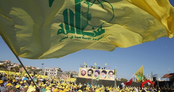 Hezbollah supporters wave the group's flag at a rally.