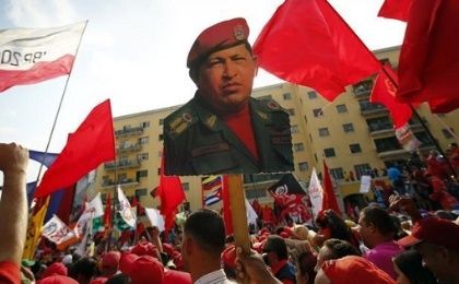 Supporters hold a poster of the late President Hugo Chavez.