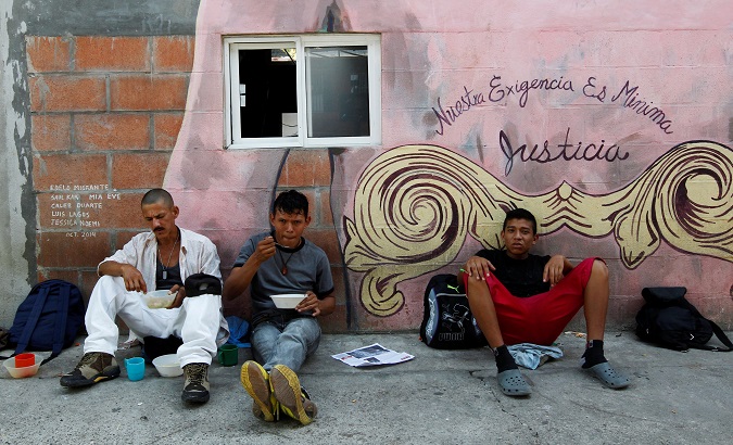 Migrants from Central America eat outside of a migrant shelter in Tabasco, Mexico.
