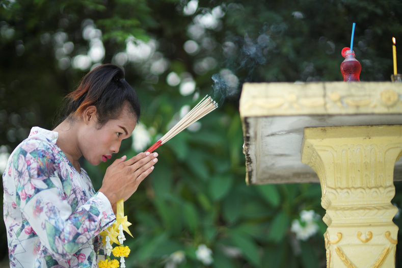 Muay Thai boxer Nong Rose Baan Charoensuk, praying at a shrine near her Baan Charoensuk gym in Thailand's Chachoengsao province.