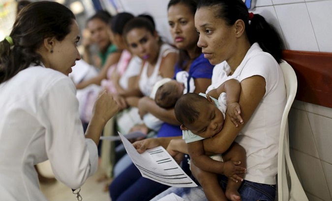 Mothers with their children await medical care at a hospital in Recife, Brazil.