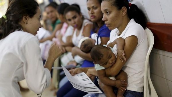 Mothers with their children await medical care at a hospital in Recife, Brazil.