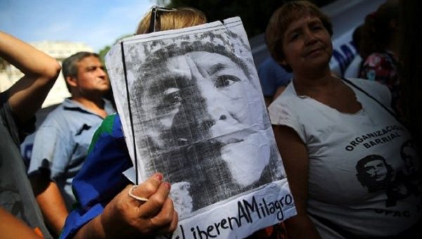 A woman holds a portrait of Milagro Sala outside the justice building in Buenos Aires, Argentina, Dec. 28, 2016.