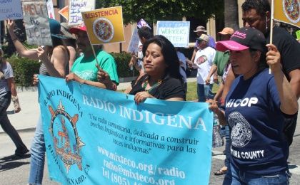 Radio Indigena community volunteers take part in workers' rights march.