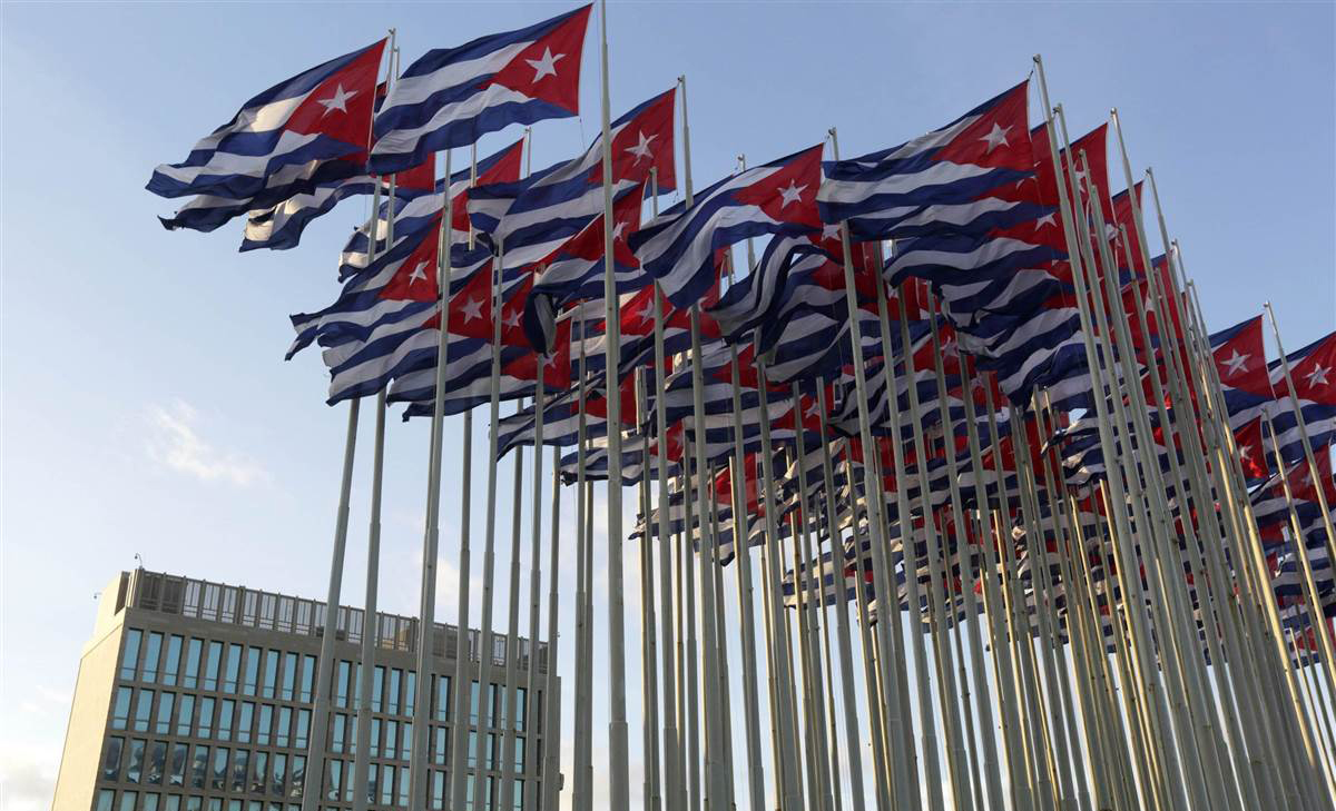 Cuban flags fly beside the United States Interests Section in Havana in Havana, December 30, 2014.