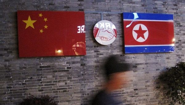 The flags of China and the Democratic People's Republic of Korea, also known as North Korea, in a Chinese Restaurant.