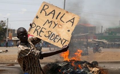 A supporter of Kenyan opposition leader Raila Odinga holds a sign in Kisumu, Kenya, on August 11, 2017.