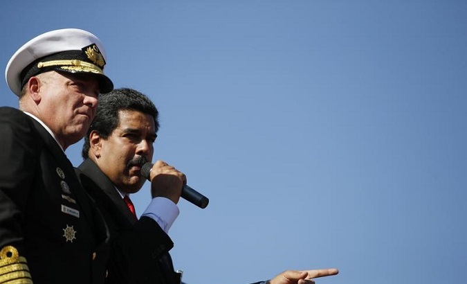 Nicolas Maduro stands next to then Defense Minister Diego Molero (L) at the Military Academy in Caracas March 7, 2013.