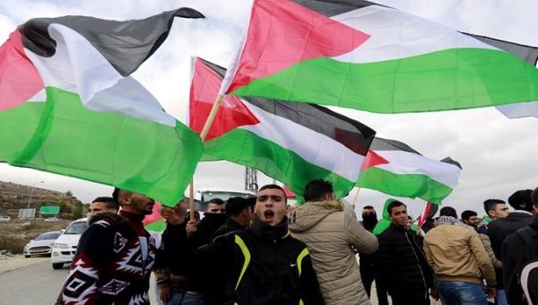 Palestinians take to the streets to celebrate the U.N. denunciation of illegal Israeli settlements.