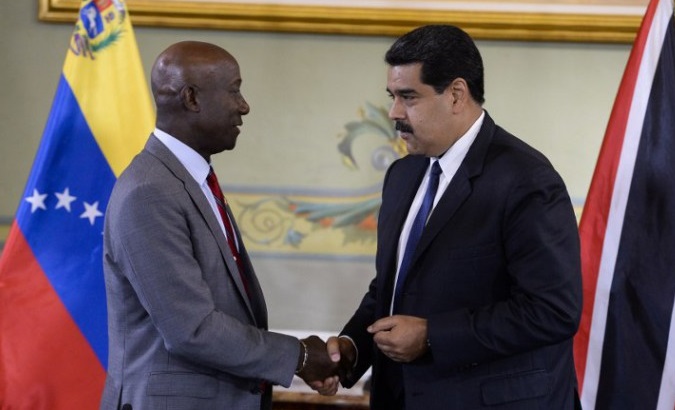 Venezuelan President Nicolas Maduro (R) and Trinidad and Tobago Prime Minister Keith Rowley (L) shake hands during a meeting in Caracas.