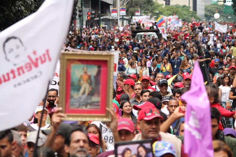 Protesters held images of Simone Bolivar to reinforce their support for the Bolivarian government.