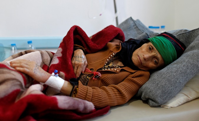 A woman with suspected cholera infection lies on a bed at a cholera treatment center in Sanaa.
