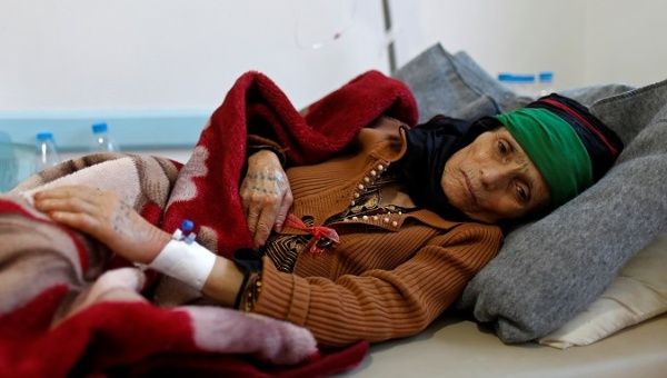 A woman with suspected cholera infection lies on a bed at a cholera treatment center in Sanaa. 