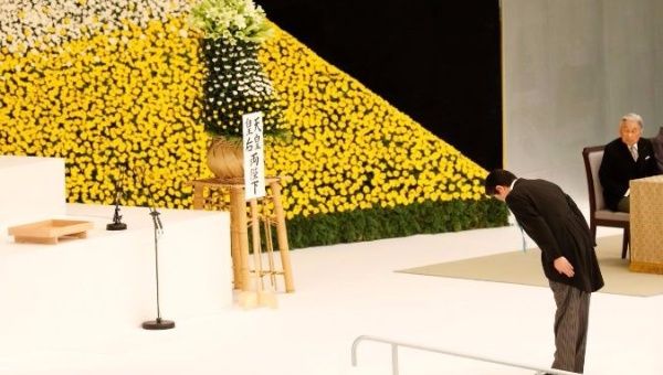 Japan's Emperor Akihito (R) looks on as PM Abe bows to an altar for the war dead marking the 72nd anniversary of Japan's surrender in WWII.
