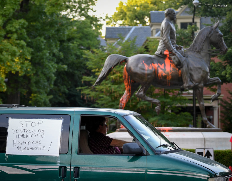 This man drove around the statue of Major Castleman with a sign saying 