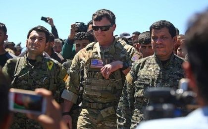 US officers visiting YPG officers at the site of Turkish airstrikes near northeastern Syrian Kurdish town of Derik on April 25, 2017.