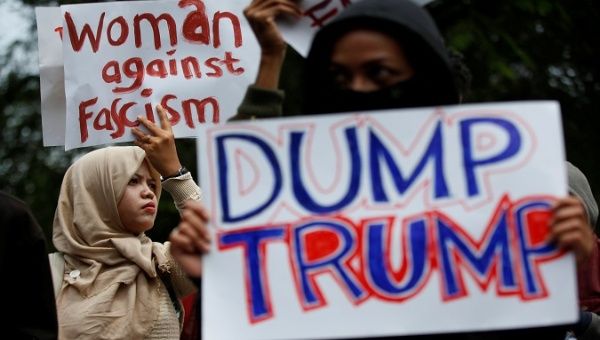 Activist hold placards as they protest against U.S. President Donald Trump’s recent policies, outside the U.S. embassy in Jakarta, Indonesia, Feb. 4, 2017.
