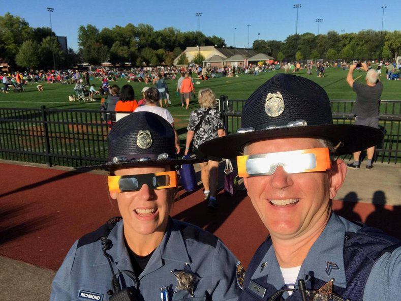 Oregon State Police officers wearing solar eclipse glasses while they wait for the eclipse at Oregon State University in Corvallis