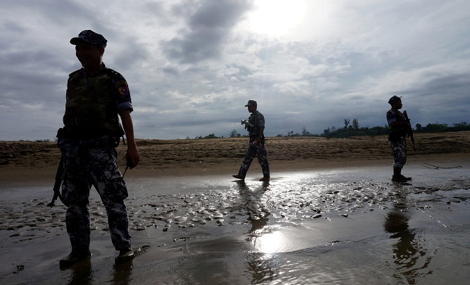 A Myanmar border guard police officers stand guard in Buthidaung, northern Rakhine state, Myanmar, on July 13, 2017.