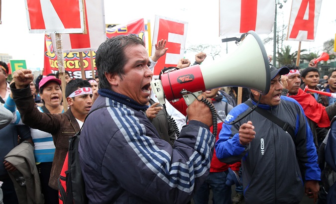 A teacher takes part in a protest in the capital city of Lima.