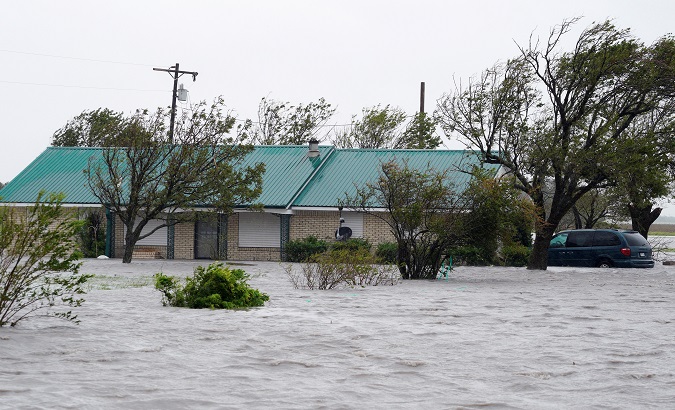 A ranch house is surrounded by floodwaters near Port Lavaca, Texas, August 26, 2017