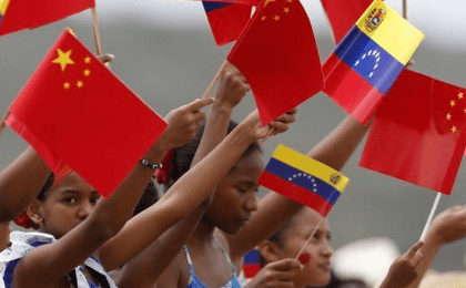 Venezuelan children wave flags as they welcome China's President Xi Jinping at Simon Bolivar International Airport in Caracas, July 20, 2014.