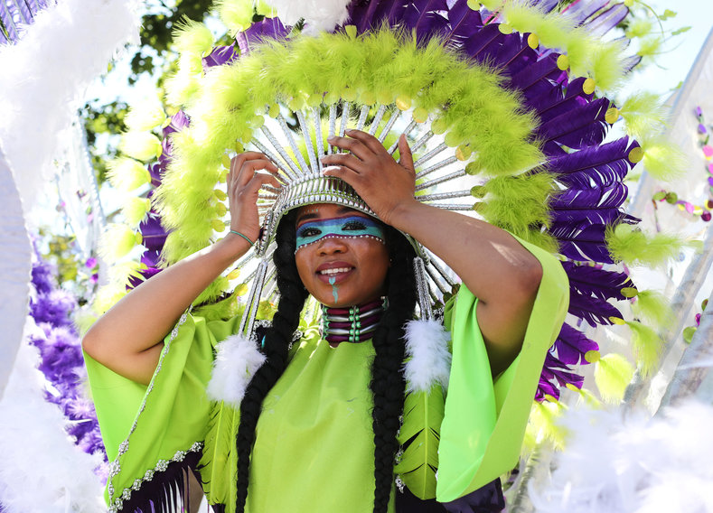 A young woman takes part in the children's parade that is part of the Notting Hill Carnival.