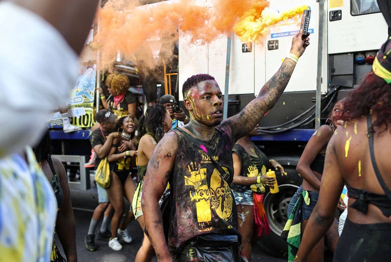 A man takes part in Jouvay celebrations in London's Notting Hill Carnival. Jouvay is held on Notting Hill Sunday.