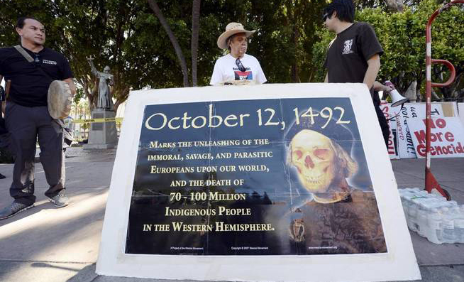 Olin Tezcatlipoca of the Mexica Movement stands with fellow protesters in an action against Father Junipero Serra.