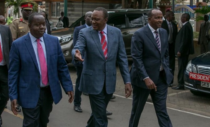 Kenya's now nullified President Uhuru Kenyatta (C) walks with Interior Cabinet Secretary Fred Matiangi and legislator Adan Duale.