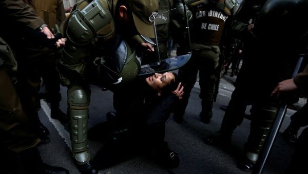 A Mapuche activist is detained during a protest in support of Santiago Maldonado.