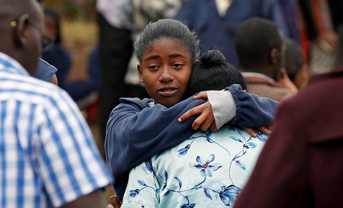 A student embraces her parent following a fire which burnt down one dormitory of Moi Girls school in Nairobi, Kenya, on September 2, 2017.